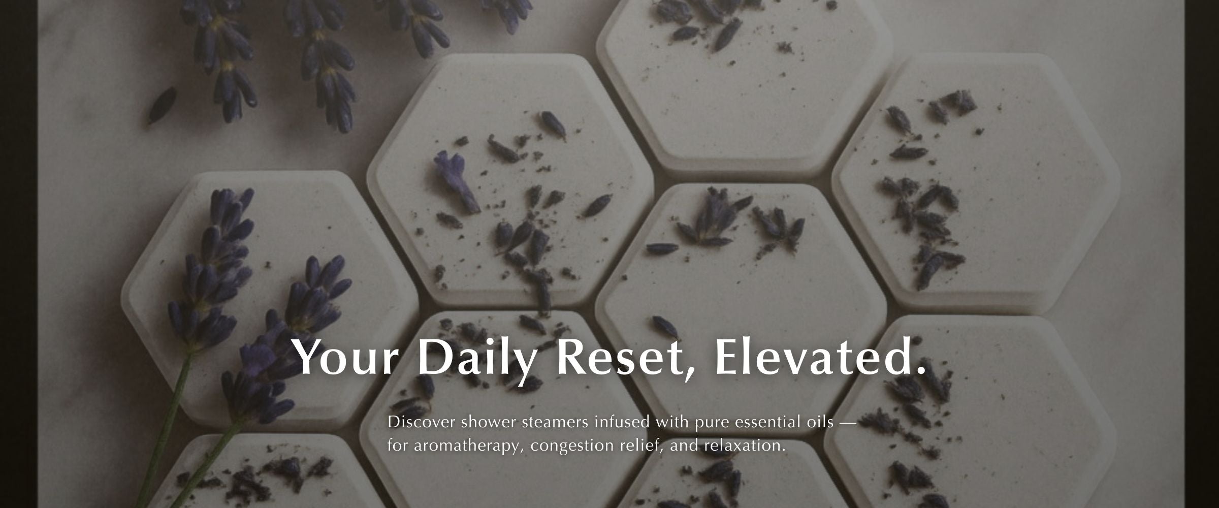 Hexagonal shower steamers with lavender  on a light background, with text 'Your Daily Reset, Elevated.'