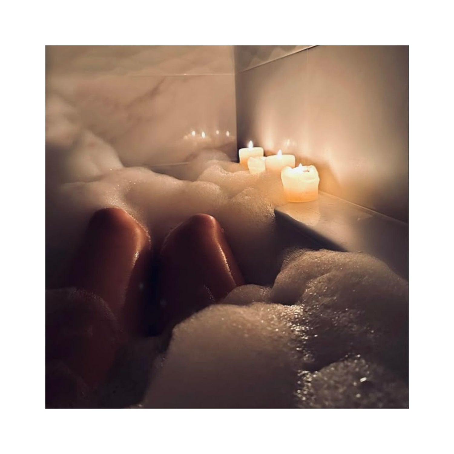 Relaxing bath with candles symbolizing Restore and Trifecta bath soaks for stress relief and sore muscle comfort. Keem Keem, Magnesium Flakes, Shower Steamers