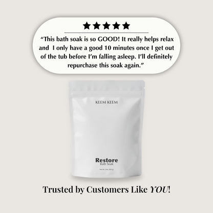 KEEM KEEM Restore Bath Soak packaging with customer review text on a light gray background