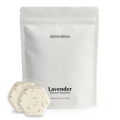 Minimalist stand-up pouch of Keem Keem Lavender Shower Steamers with two hexagon tablets displayed in front, showing lavender buds and premium packaging design.