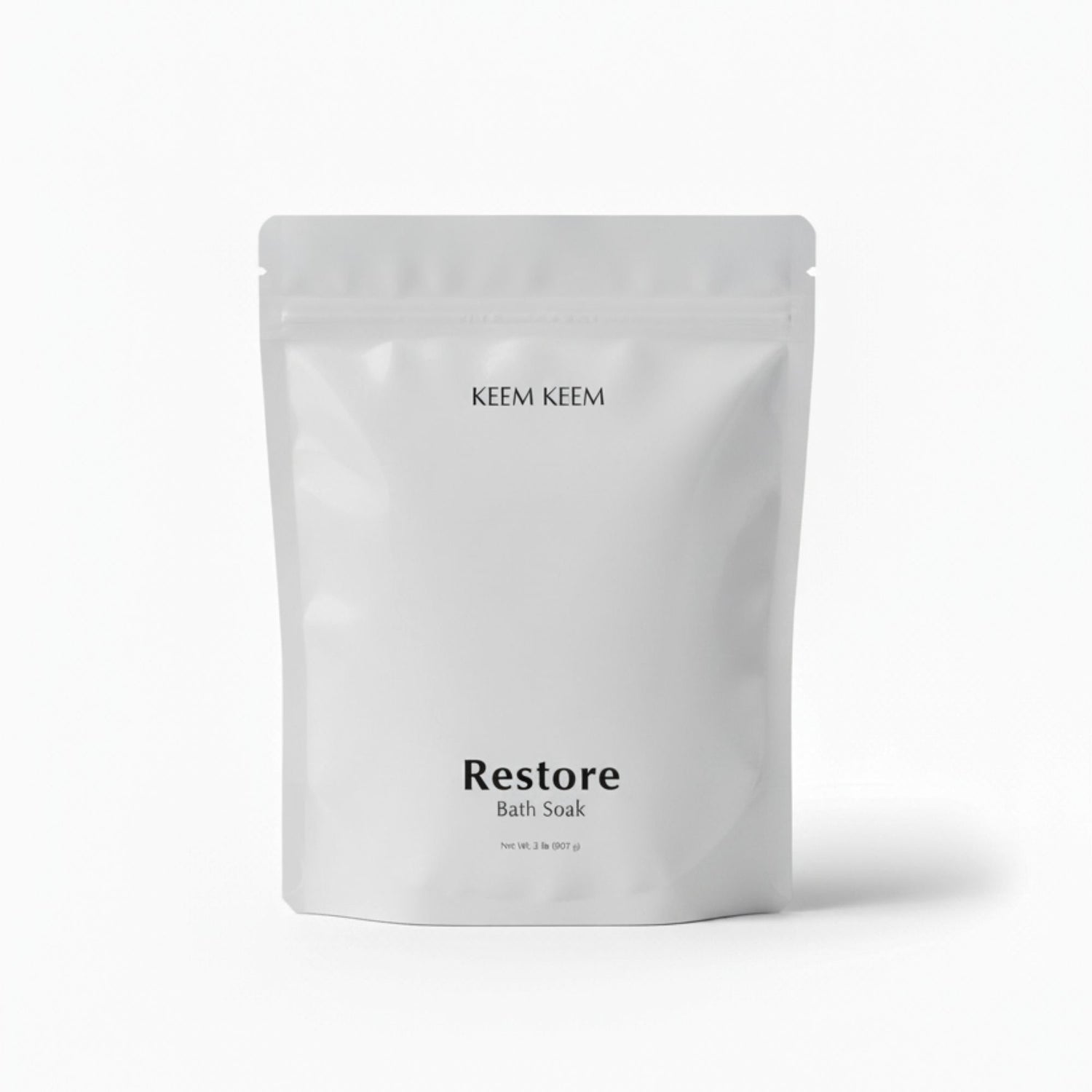 Minimal luxury image of Keem Keem Restore Bath Soak in a clear pouch, designed for magnesium replenishment and stress recovery.