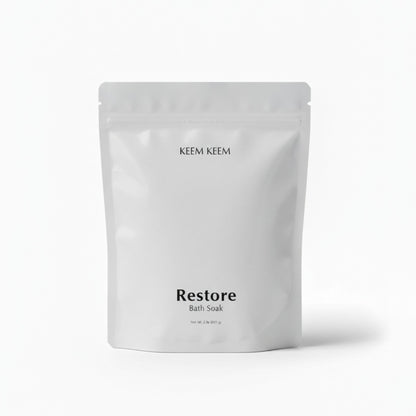 Minimal luxury image of Keem Keem Restore Bath Soak in a clear pouch, designed for magnesium replenishment and stress recovery.